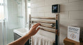 Electric towel rail with thermostatic wall controller set to 48°C — real installation, Coventry