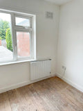 Reina Serre WiFi electric convector radiator installed under a bedroom window in Robert's Derby flat