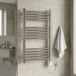Metal towel rack mounted on a bathroom wall with a towel hanging on it.