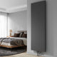 Reina Borda anthracite vertical mild steel radiator in a modern bedroom