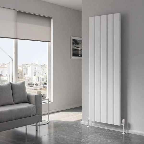 Reina Caldaro vertical aluminium radiator in white in a grey living room with a sofa