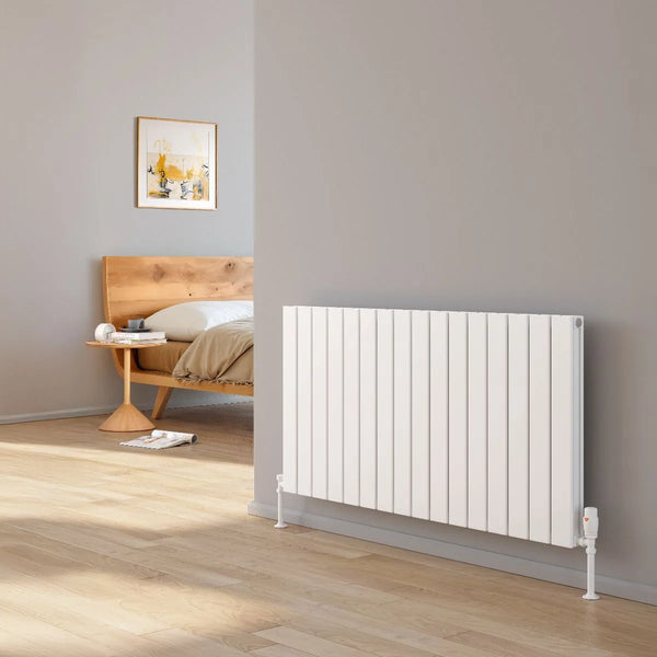 Reina Piatto horizontal aluminium radiator in white fitted in a light grey bedroom