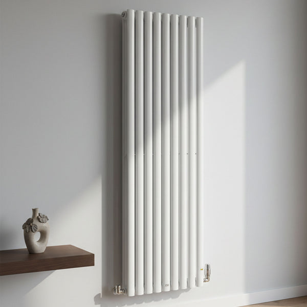 White vertical radiator on a light gray wall with a wooden shelf and decorative vase.