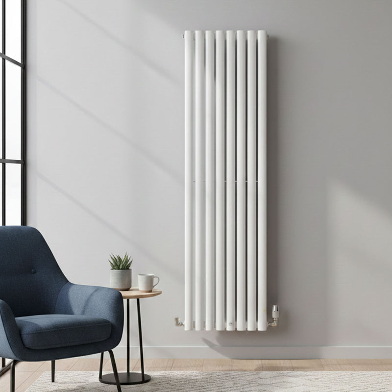 White vertical radiator on a gray wall with a blue armchair and small table in the foreground.